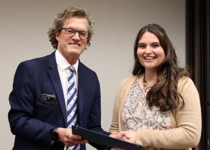 Man presenting woman with an award.